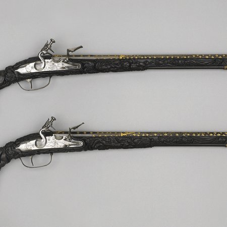 An image of two flint-lock pistols