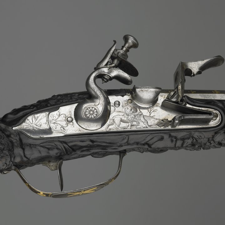 A detail of the firing mechanism of a flint-lock pistol