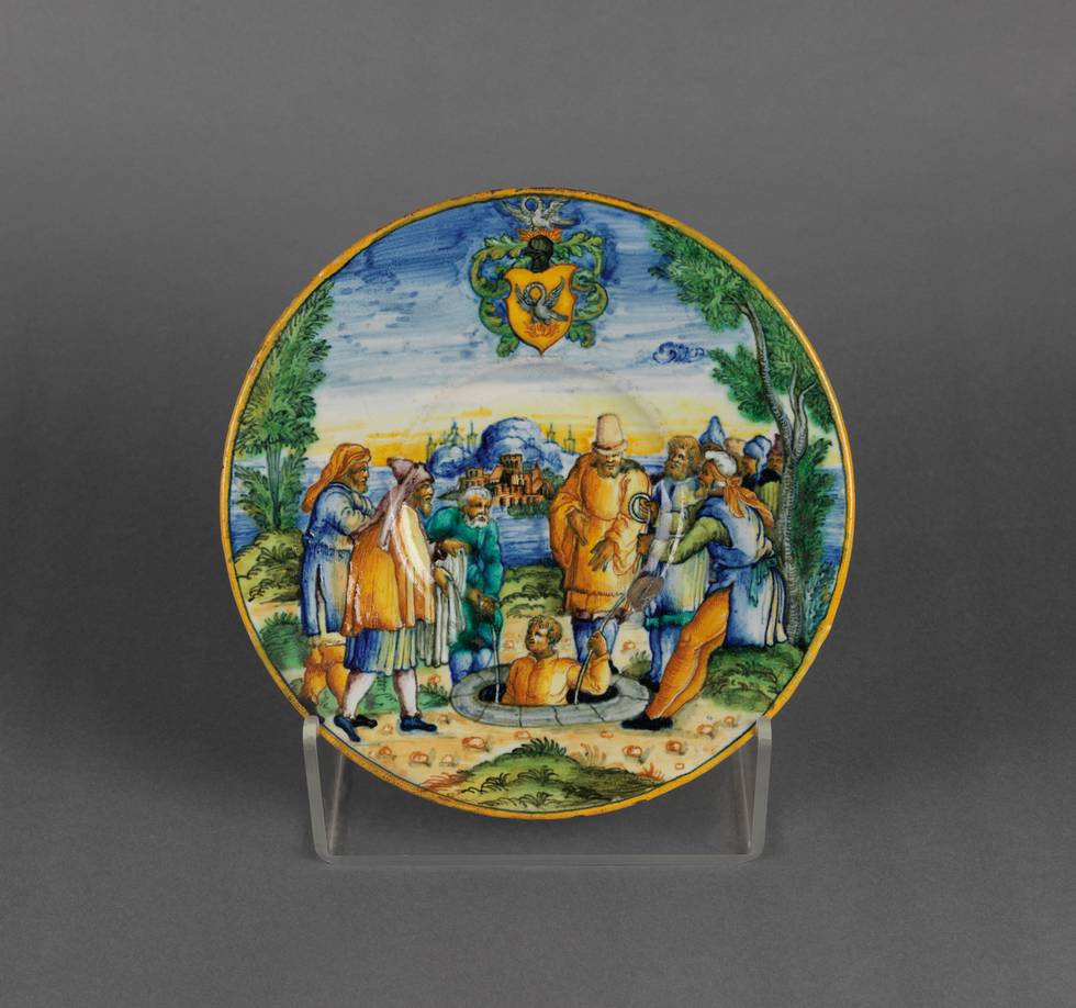 Plate with illustration of Joseph being lowered into well by his brother