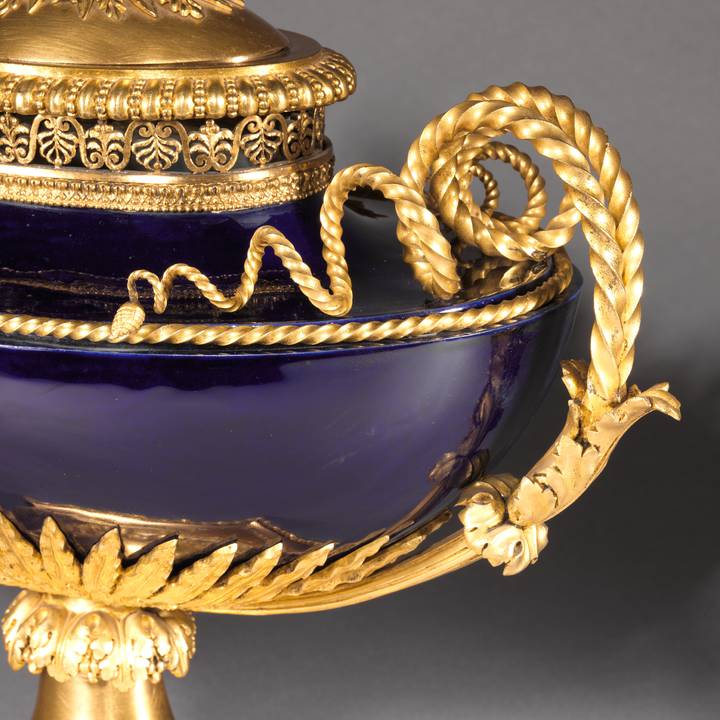 A detail of a porcelain vase mounted in gilt bronze