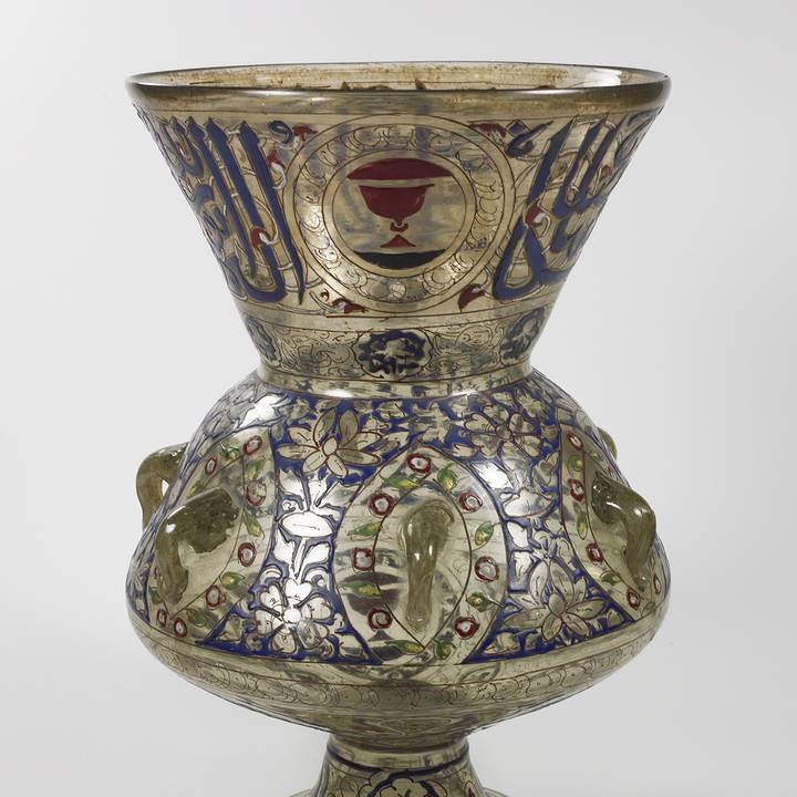 Glass lamp with blue and gold illustrations of fish and flowers