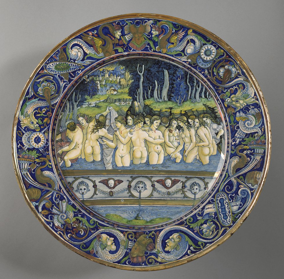 A earthenware dish decorated with a scene of women bathing