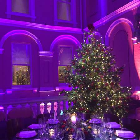 A table set for dinner and a Christmas tree