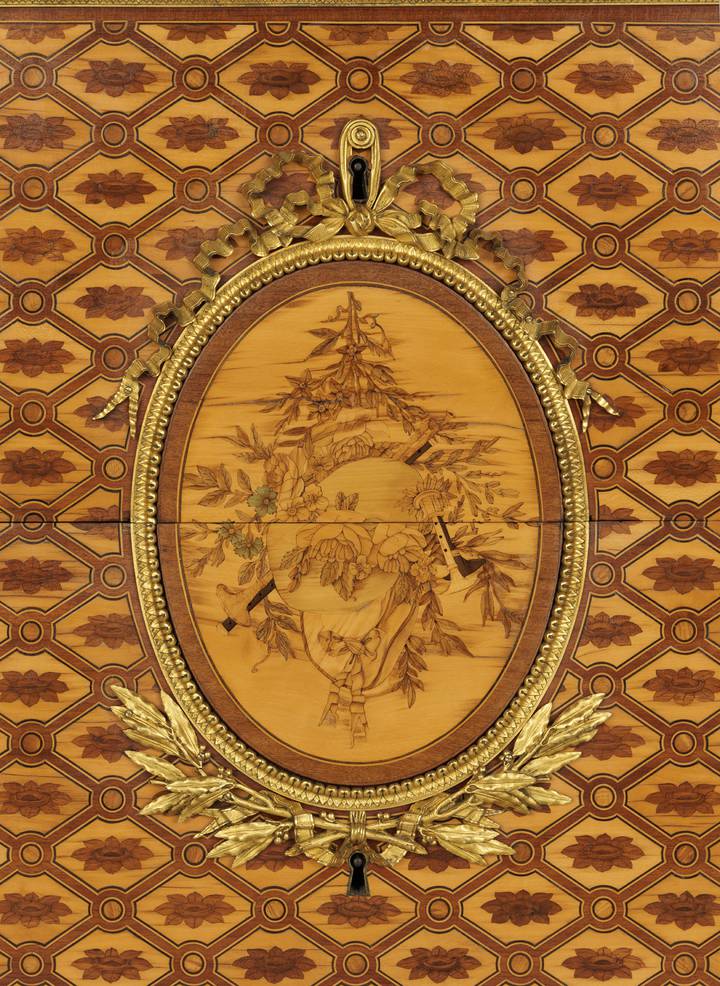 Detail of marquetry plaque, showing pastoral attributes. Attributed to Jean-Henri Riesener, Chest-of-drawers, 1780 (F247).
