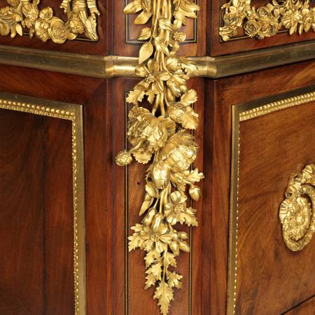 A detail of gilt-bronze mounts on a chest-of-drawers
