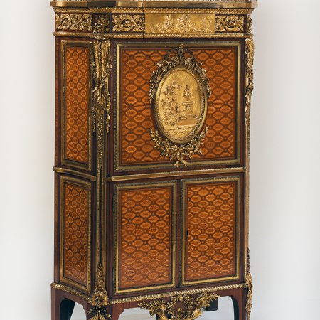 Wooden desk, with central medallion of women and child next to statue