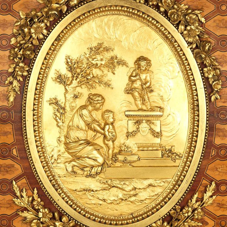 Close up of wooden furniture with gilded figures