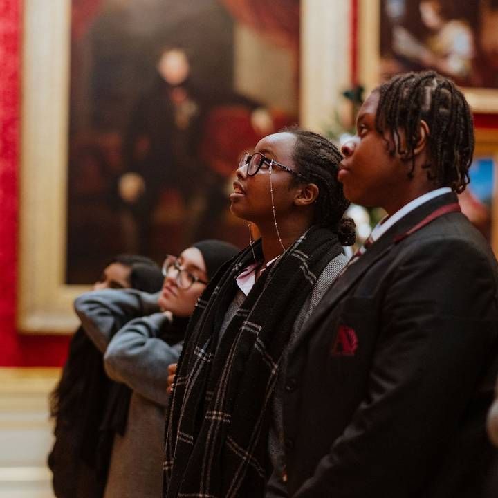 school children looking at painting