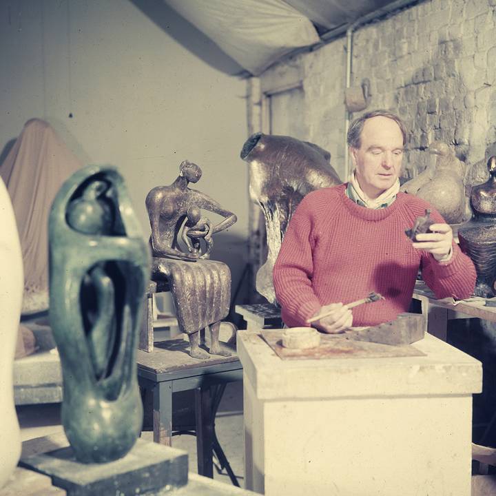 Henry Moore in studio working on sculpture