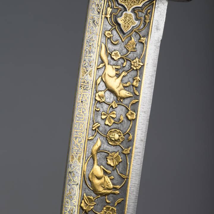 Jade and gold inlaid dagger with foliage and two foxes