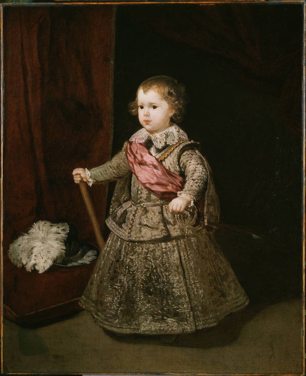 Full length portrait of young boy in costume holding baton