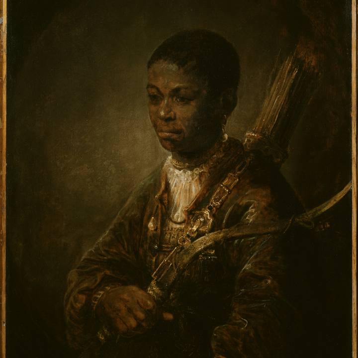 Full length portrait of young boy in costume holding baton
