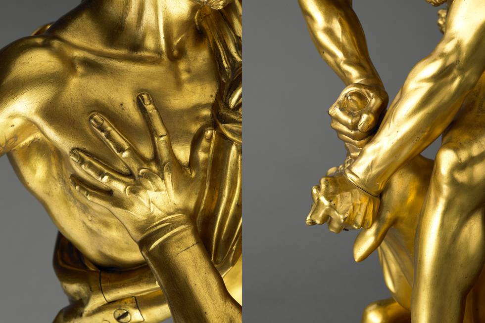 Detail of hands of two bronze sculptures of a man fighting a bull and centaur