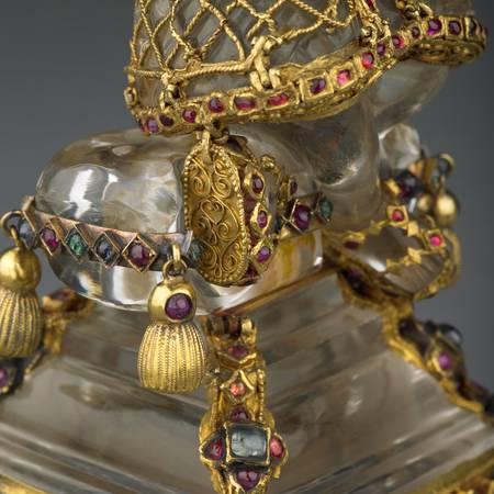 Detail of bottom half of statue of christ as Shepard decorated with gold and jewels