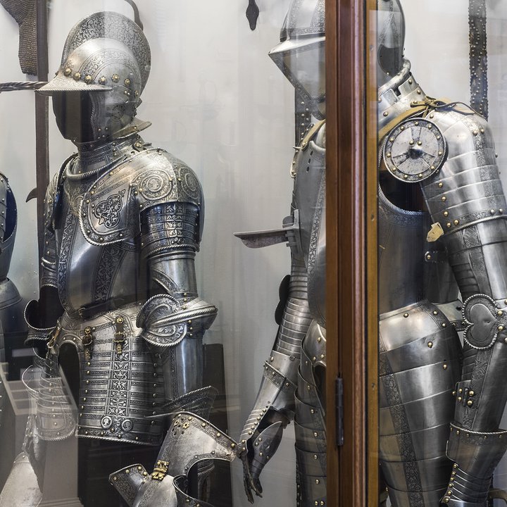 An image of armours in a case in an arms and armour gallery