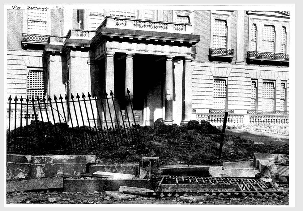 Black and white photo of front of Hertford house with bomb damage