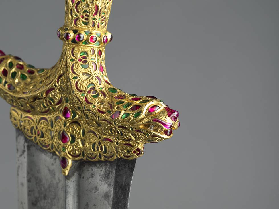 Detail of gold jewelled dagger handle with lion head