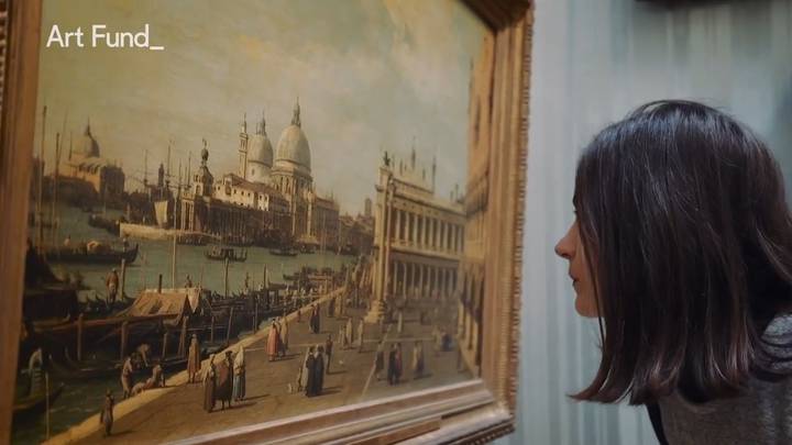 An image of a woman looking at a painting of Venice